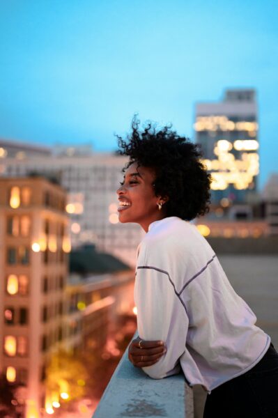 woman overlooking new york city from above at sunset