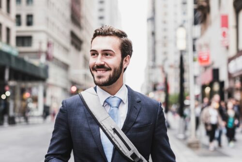 Business person in his 30s walking along a street in NYC