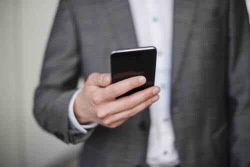 Close-up of businessman holding cell phone