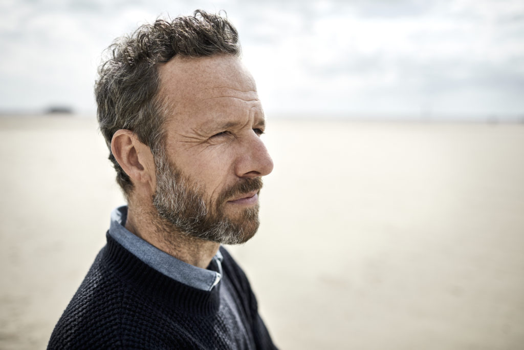 Portrait of pensive bearded man on the beach