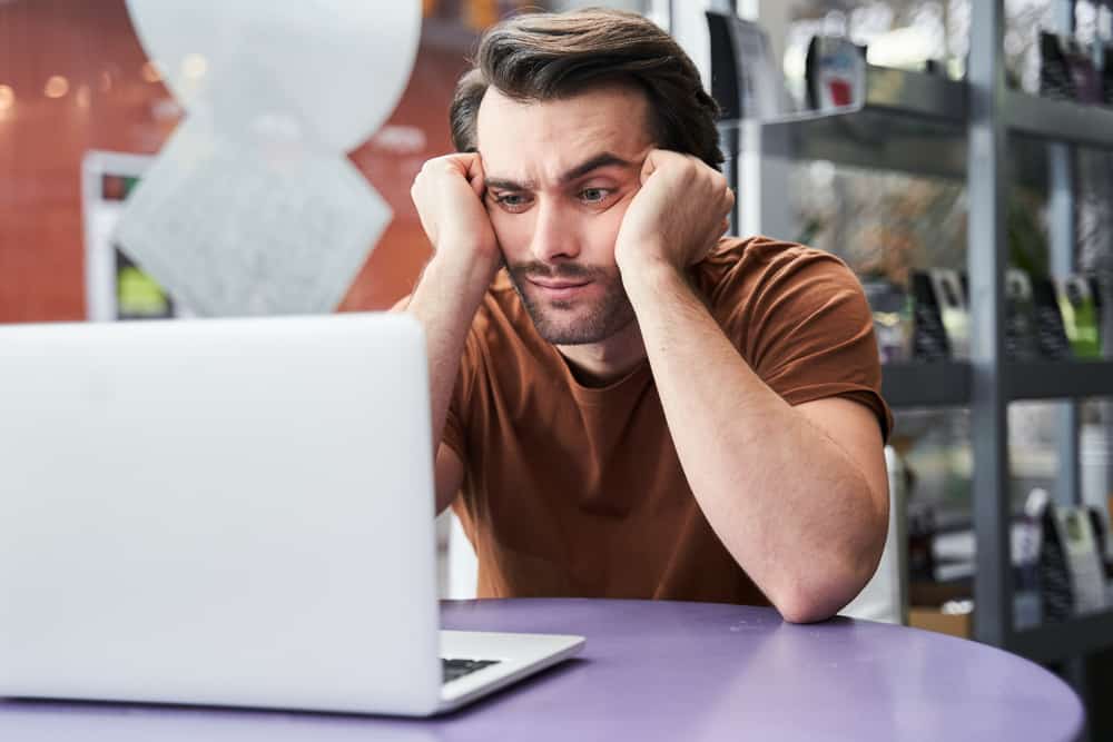 Man with ADHD trying to focus at a computer