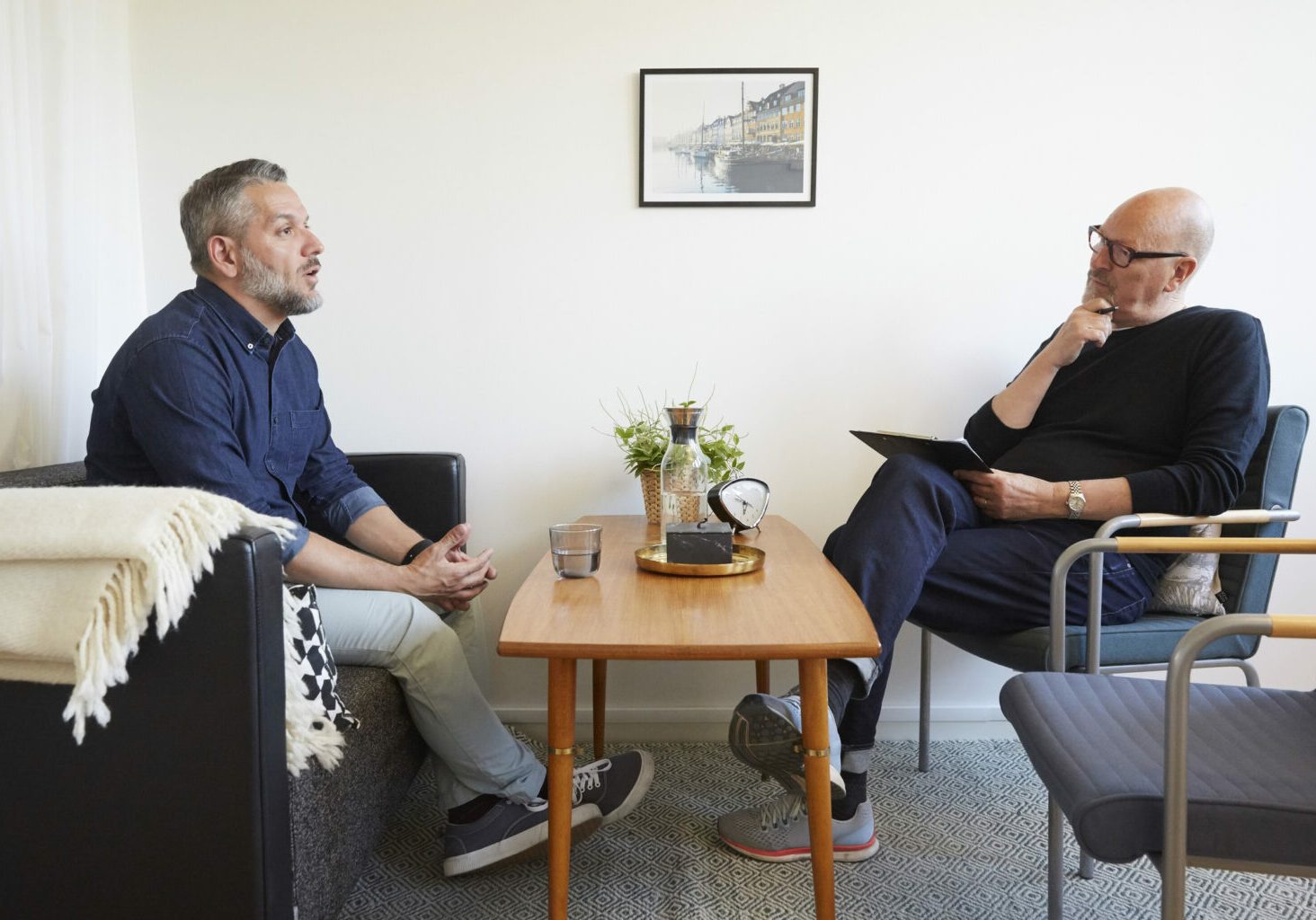 Mature man talking to senior therapist at community center